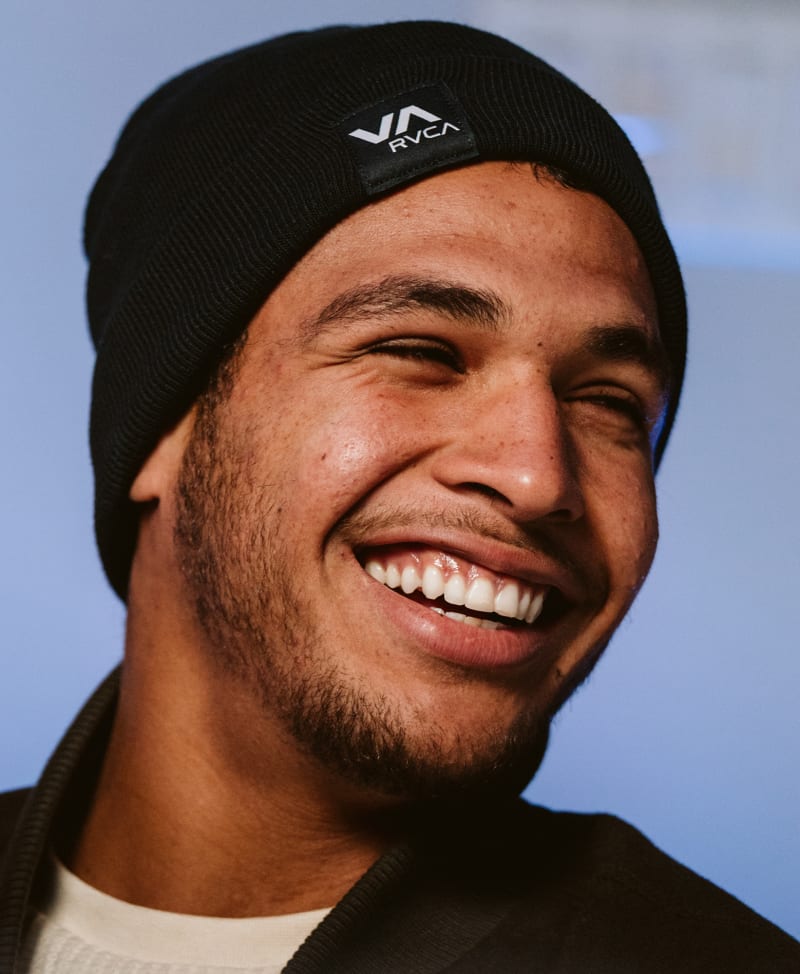 Tye Ruotolo in the JAXXON Podcast Studio, smiling and wearing a black jacket with a black beanie cap.
